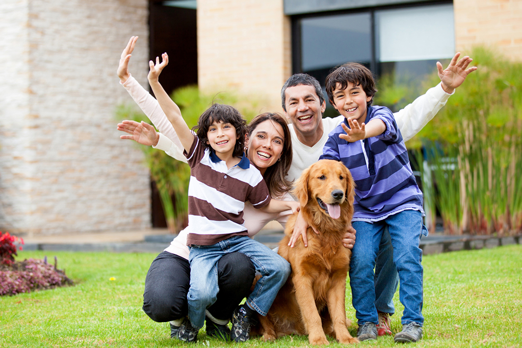 Happy Family Smiling with Dog